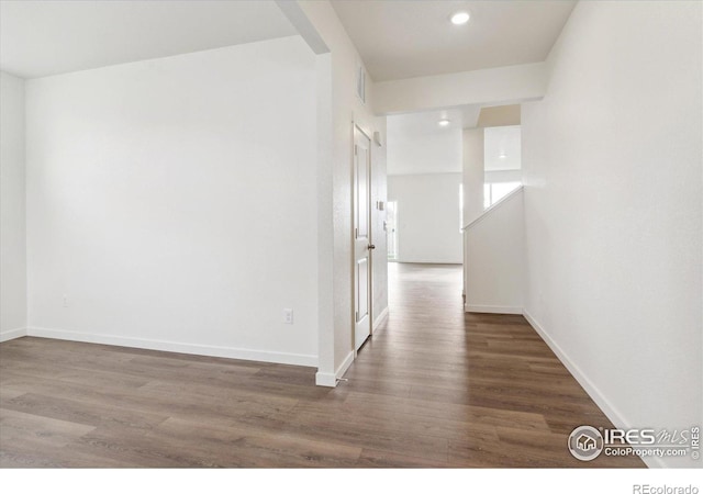 corridor with dark hardwood / wood-style floors