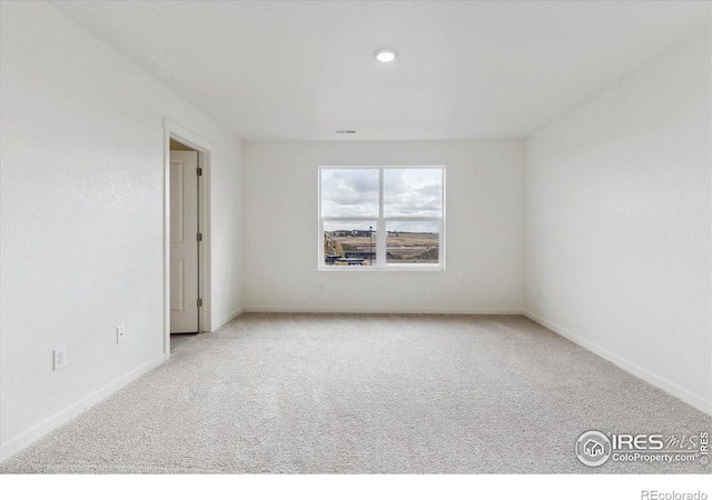 empty room featuring light carpet