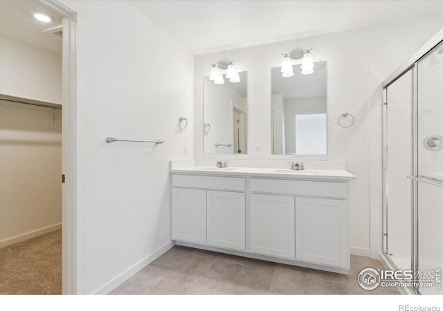 bathroom with vanity and a shower with door