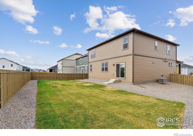 back of property with a patio, central AC unit, and a lawn