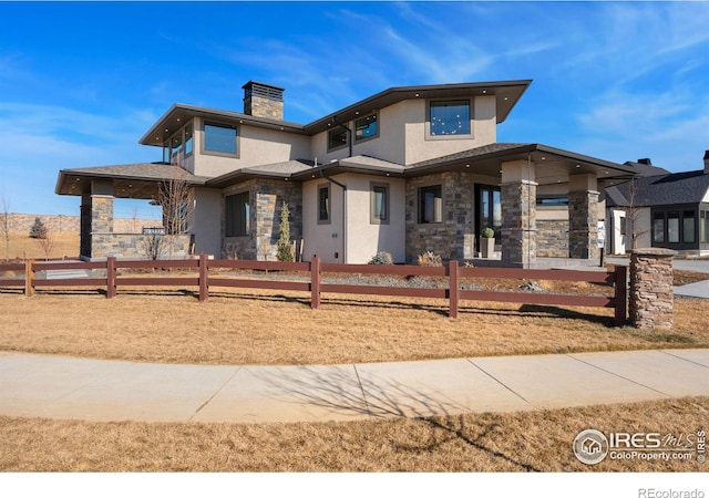 3650 Tall Grass Ct, Timnath, CO 80547 - view of front facade with stone siding, stucco siding, and a chimney