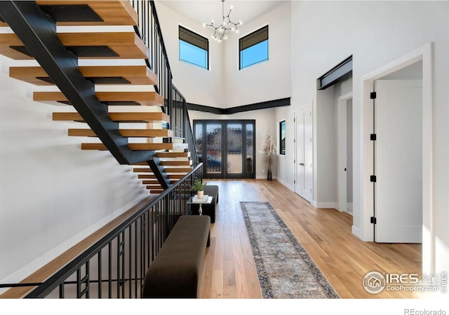 3650 Tall Grass Ct, Timnath, CO 80547 - entryway with a chandelier, a high ceiling, french doors, wood finished floors, and baseboards