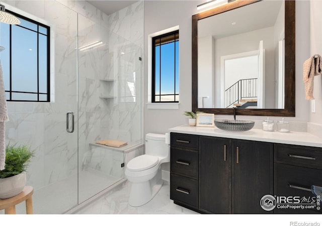 3650 Tall Grass Ct, Timnath, CO 80547 - bathroom featuring marble look tile flooring, a marble finish shower, toilet, and vanity