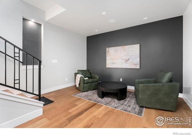 3650 Tall Grass Ct, Timnath, CO 80547 - living area featuring wood finished floors, stairway, and baseboards