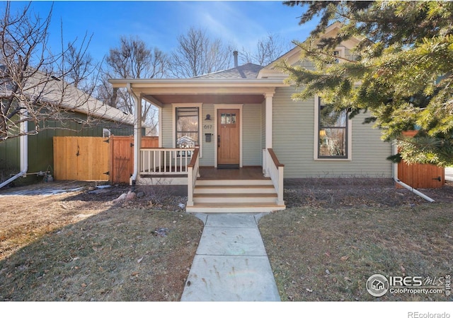 view of front of home featuring covered porch and a gate