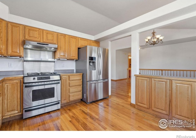 kitchen with an inviting chandelier, stainless steel appliances, and light wood-type flooring