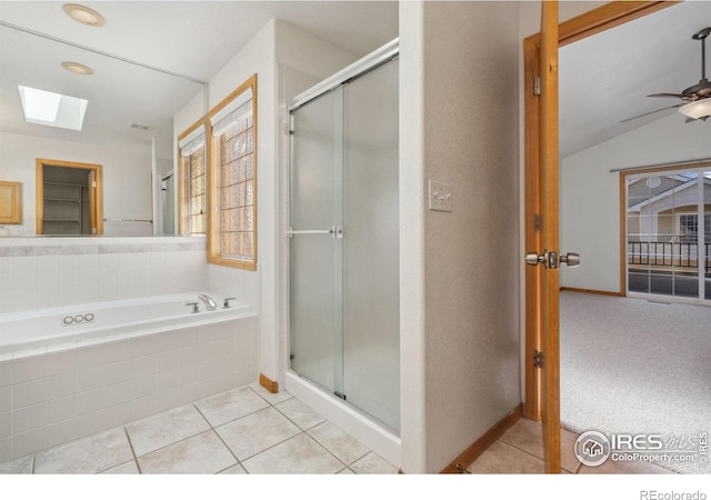 bathroom featuring ceiling fan, tile patterned floors, lofted ceiling with skylight, and independent shower and bath