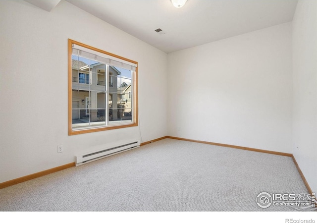 carpeted spare room featuring a baseboard radiator