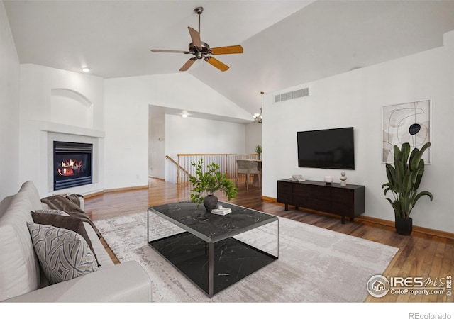 living room featuring ceiling fan, lofted ceiling, and hardwood / wood-style floors