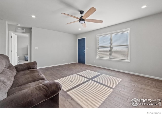 living room with ceiling fan and hardwood / wood-style floors