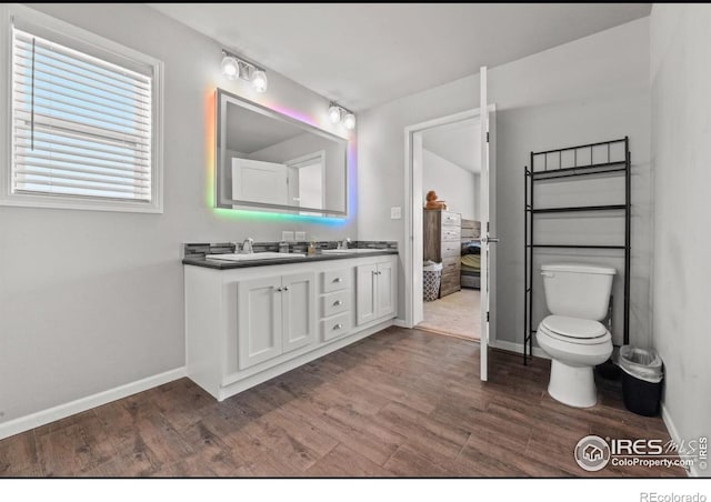 bathroom with vanity, hardwood / wood-style floors, and toilet