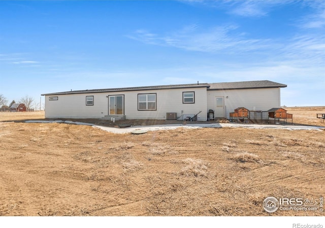 rear view of property with central AC and a patio