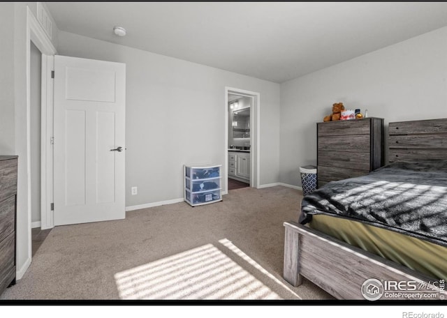 carpeted bedroom featuring ensuite bathroom