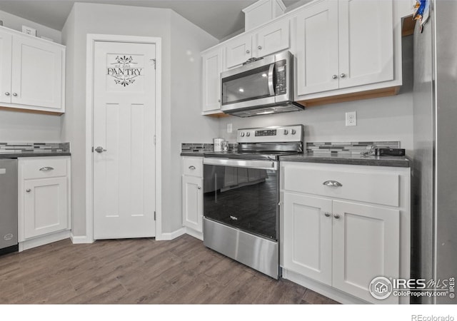 kitchen featuring white cabinetry, dark hardwood / wood-style flooring, and appliances with stainless steel finishes