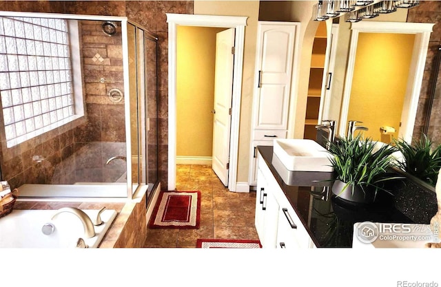 2023 81st Ave, Greeley, CO 80634 - bathroom with a shower stall, a tub with jets, vanity, and tile patterned flooring