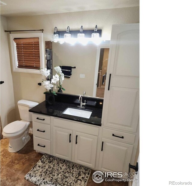2023 81st Ave, Greeley, CO 80634 - bathroom with vanity and toilet