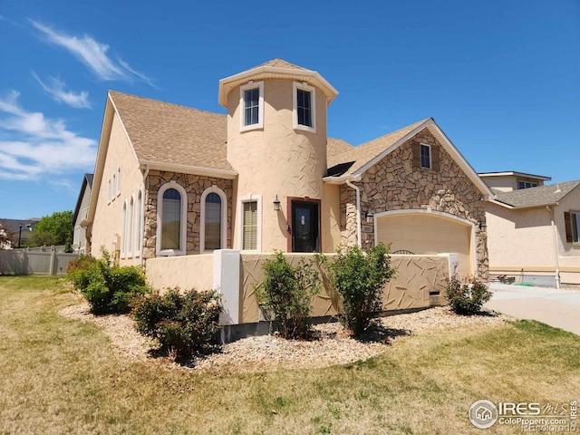 2023 81st Ave, Greeley, CO 80634 - view of front of home featuring stone siding, a garage, roof with shingles, driveway, and stucco siding