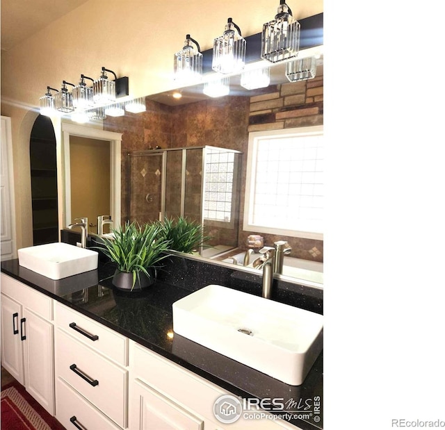 2023 81st Ave, Greeley, CO 80634 - bathroom with double vanity, a shower stall, and a bath