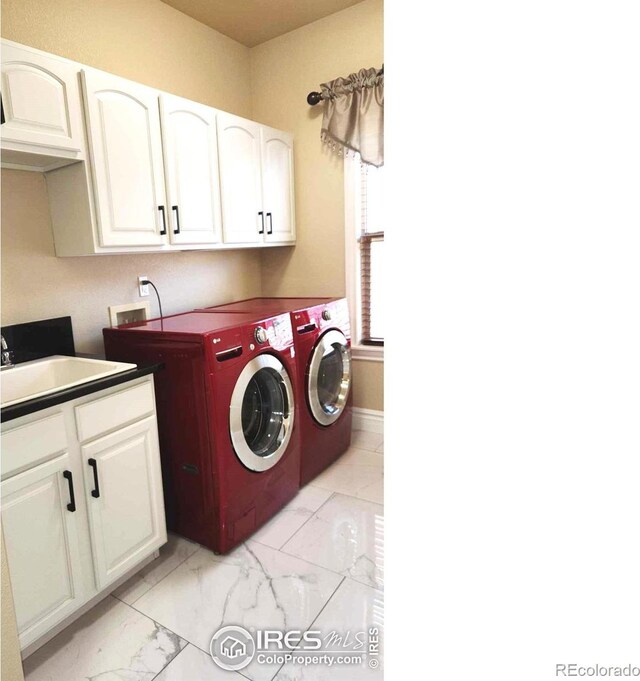 2023 81st Ave, Greeley, CO 80634 - washroom with washing machine and dryer, cabinet space, and light marble finish flooring