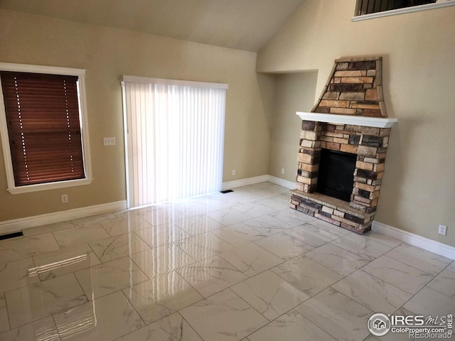 2023 81st Ave, Greeley, CO 80634 - unfurnished living room with marble finish flooring, a fireplace, and vaulted ceiling
