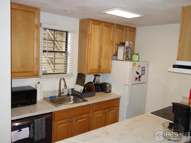 kitchen with dishwasher, sink, and white fridge