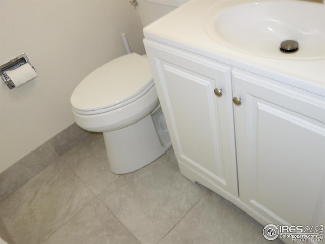 bathroom featuring vanity, tile patterned flooring, and toilet