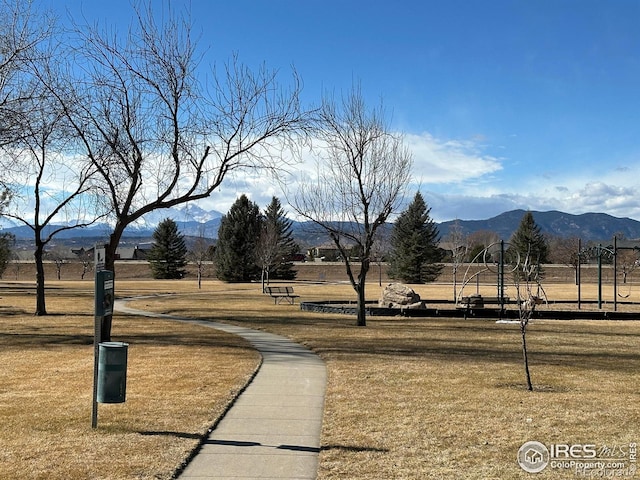 surrounding community featuring a yard and a mountain view