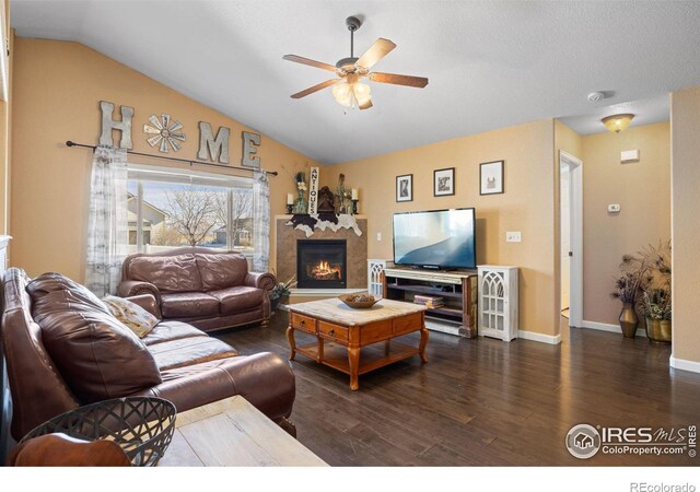 living room with lofted ceiling, dark wood-type flooring, and ceiling fan