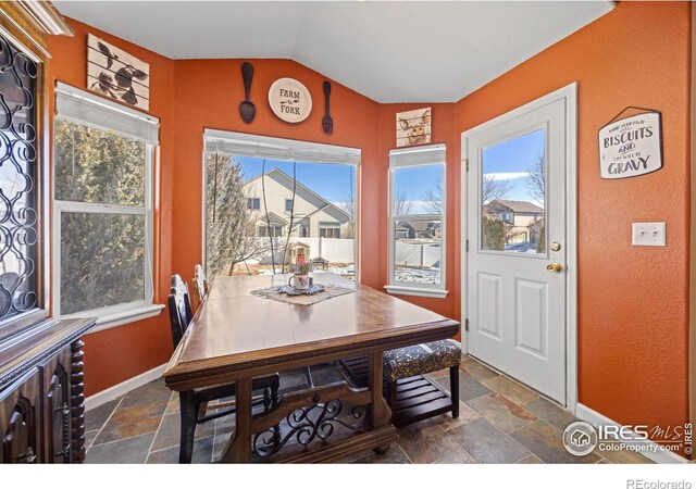 dining space with vaulted ceiling