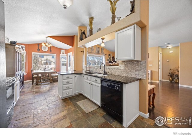 kitchen featuring black dishwasher, sink, white cabinets, and kitchen peninsula