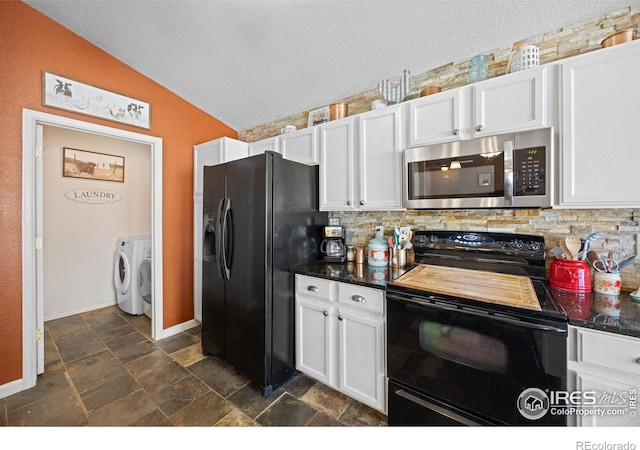 kitchen featuring washer and dryer, white cabinetry, lofted ceiling, decorative backsplash, and black appliances