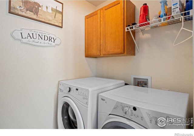 laundry area with cabinets and washer and clothes dryer