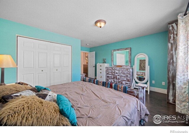 bedroom with dark wood-type flooring and a closet