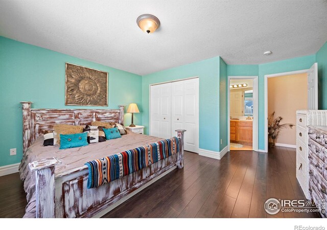 bedroom with a textured ceiling, dark hardwood / wood-style flooring, and a closet