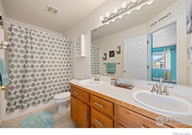 bathroom featuring vanity, tile patterned floors, toilet, and a shower with shower curtain