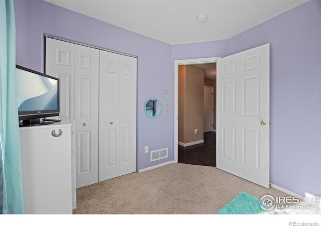 unfurnished bedroom featuring carpet floors and a closet