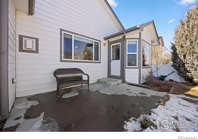 entrance to property featuring a patio area