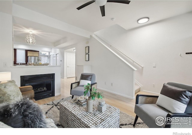 living room with light hardwood / wood-style floors and ceiling fan