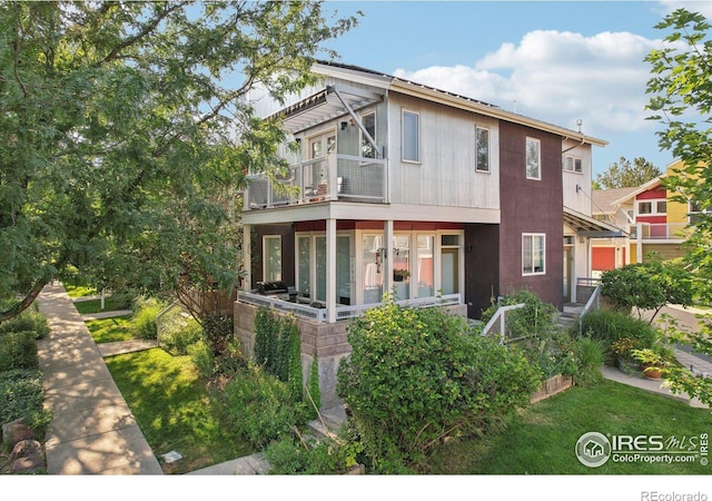 rear view of property featuring a balcony