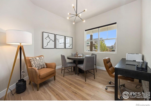 office area with an inviting chandelier and light hardwood / wood-style floors