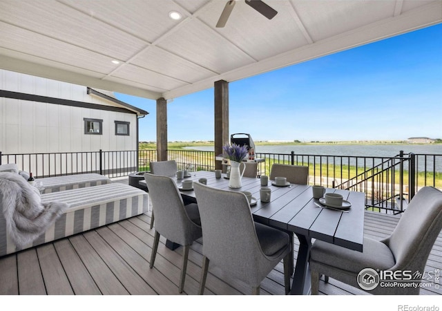 wooden deck featuring a water view and ceiling fan