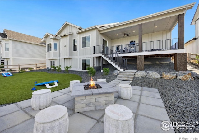 view of patio featuring ceiling fan and an outdoor fire pit