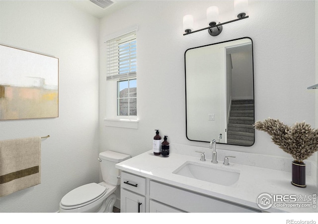 bathroom featuring vanity and toilet