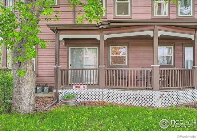 820 Kimbark St Unit B, Longmont, CO 80501 - doorway to property with covered porch and a yard