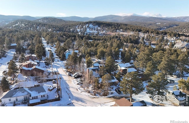 snowy aerial view featuring a mountain view