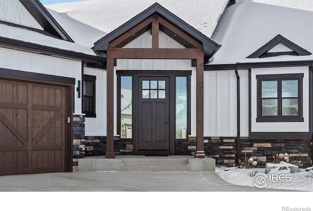 entrance to property with stone siding and board and batten siding