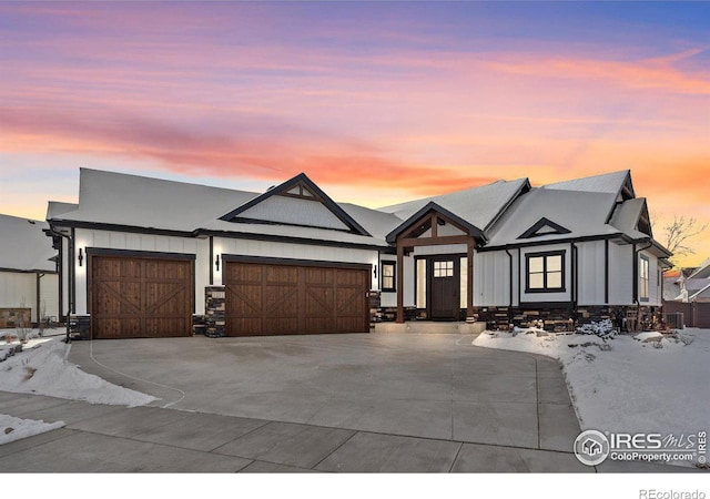 view of front facade with a garage, board and batten siding, and concrete driveway