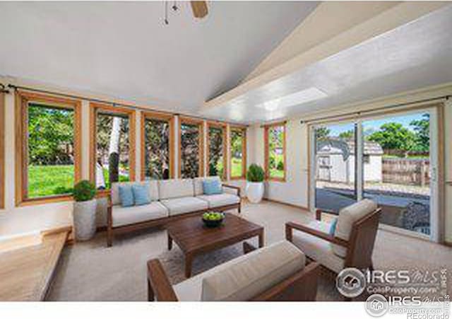 living room featuring lofted ceiling, light carpet, and ceiling fan