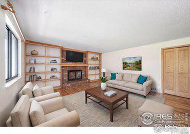 living room featuring a fireplace and light hardwood / wood-style floors