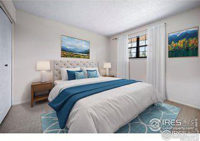 carpeted bedroom featuring a textured ceiling